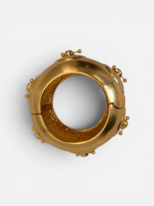 Hammered Gold bracelet with a unique nipple piercing design.